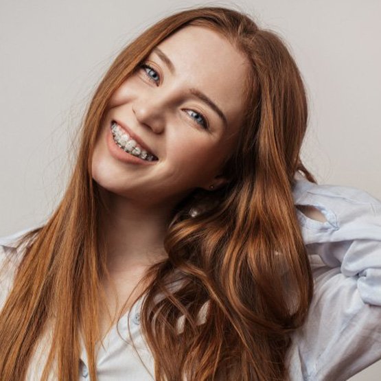 Young lady smiles with braces