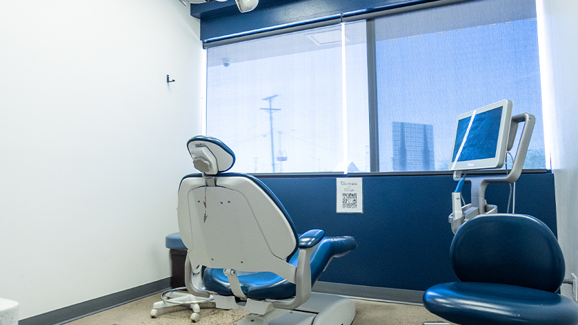 Dental treatment room with dark blue leather chair