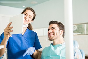 Dentist showing patient image on tablet