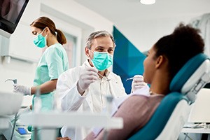 Dentist smiling at patient during dental exam