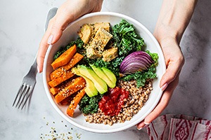 Patient holding bowl of nutrient-dense foods