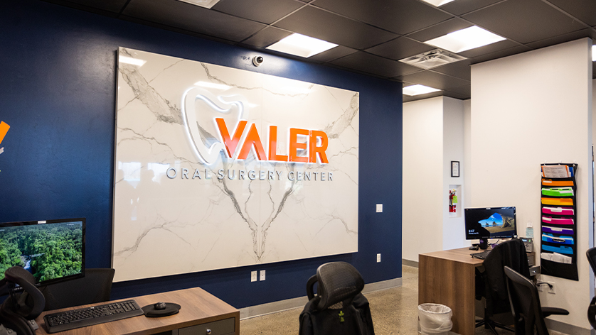 Valer Oral Surgery Center sign behind dental office front desk