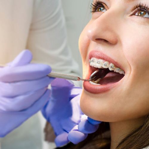 a patient getting her braces checked by her orthodontist