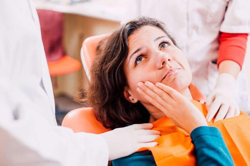 Woman in the dental chair with a toothache